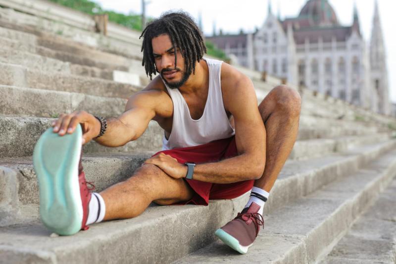 Workout clothes, man stretching.